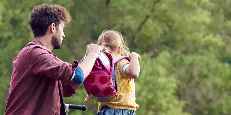 Man packing a childs rucksack