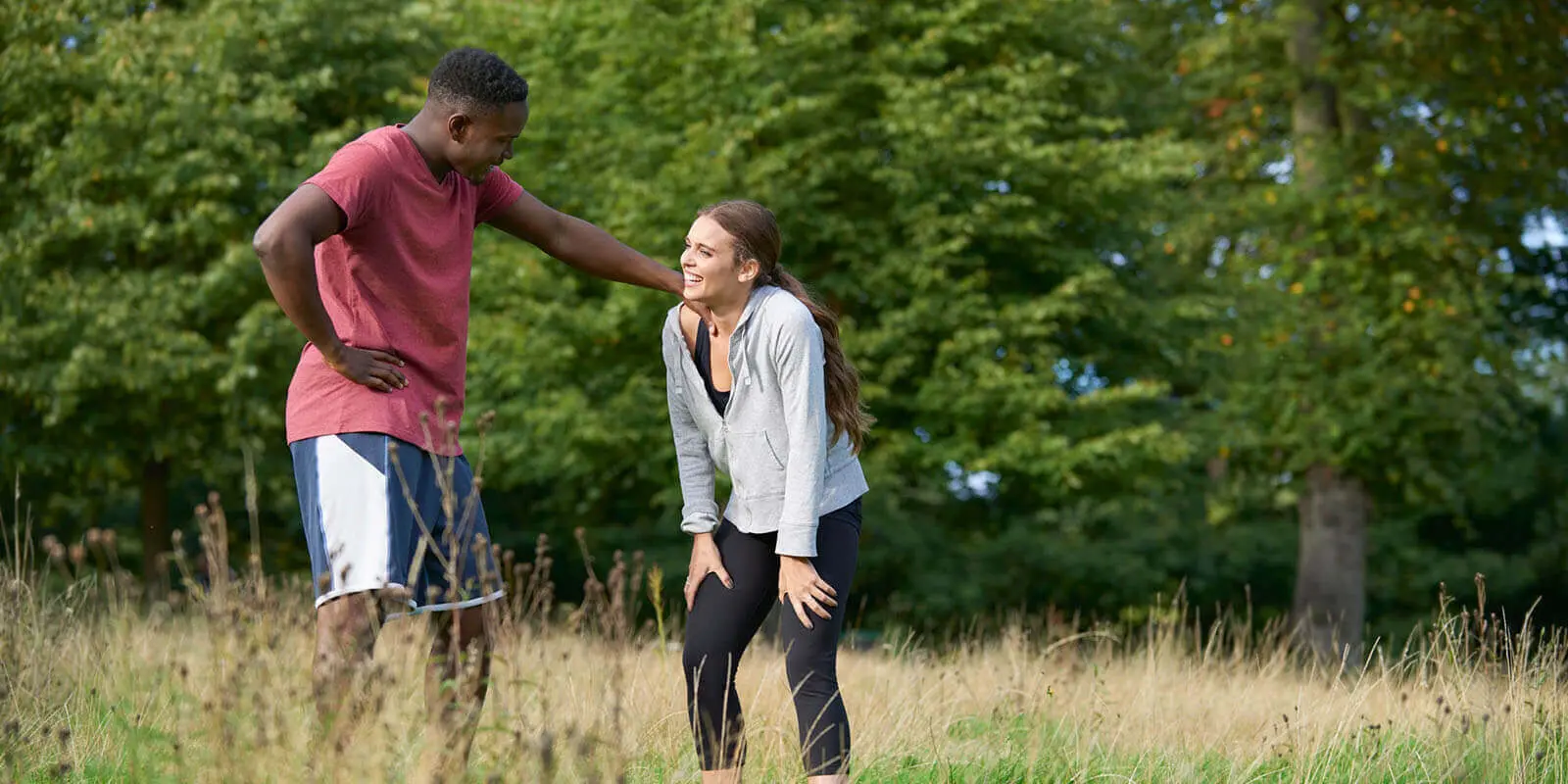 Man and woman catching breath after running